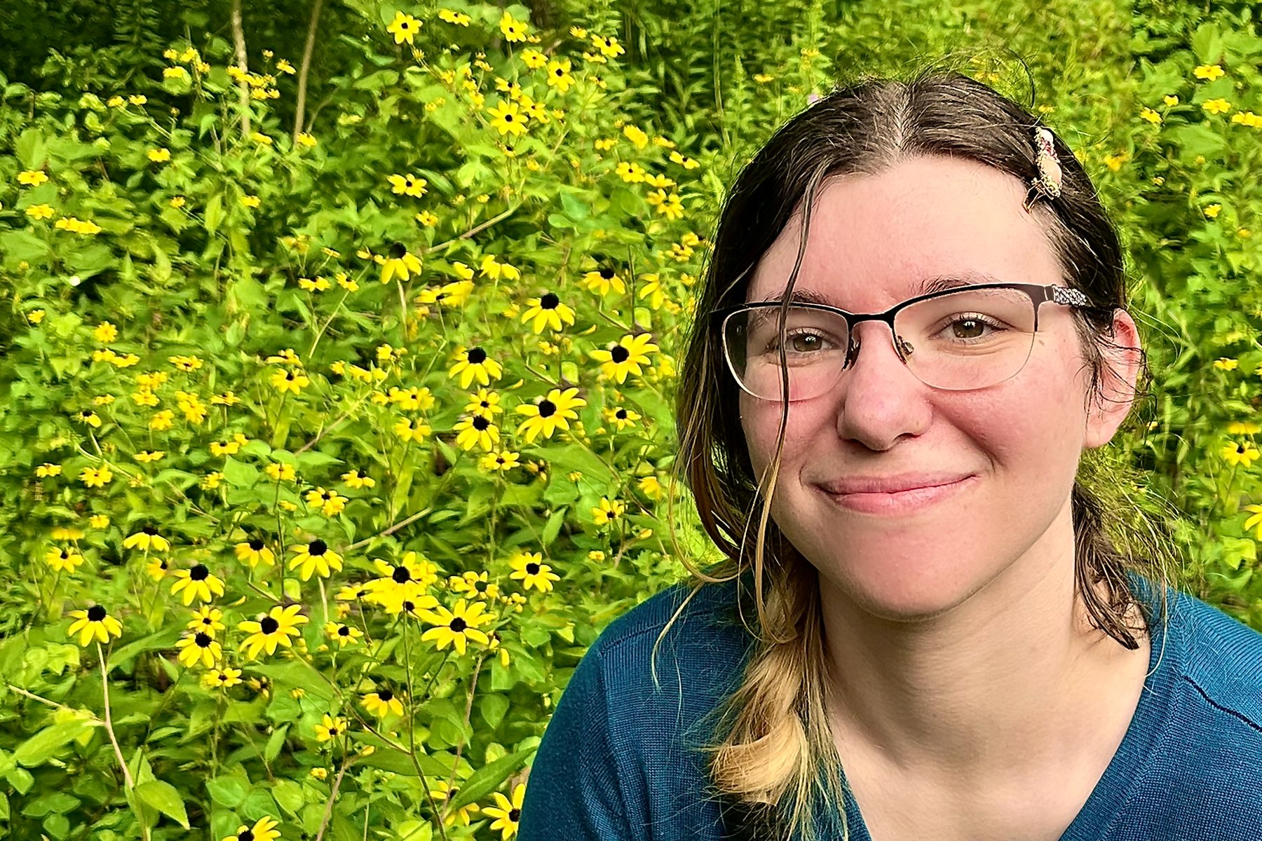 Bri, smiling outdoors