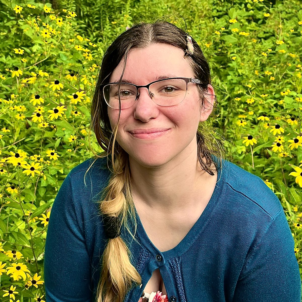 Bri, smiling outdoors