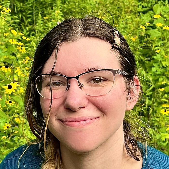Bri, smiling outdoors